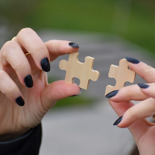 a person holding a pair of nails